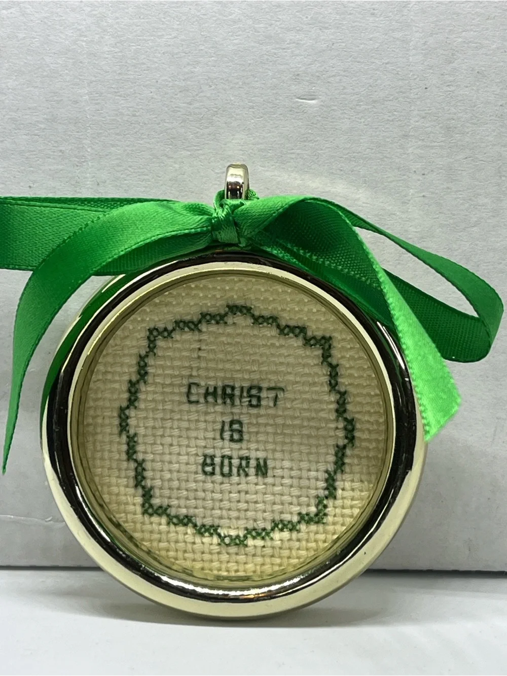 Hand Crafted Christ Is Born Cross-Stitched Holiday Ornament with Green Ribbon
